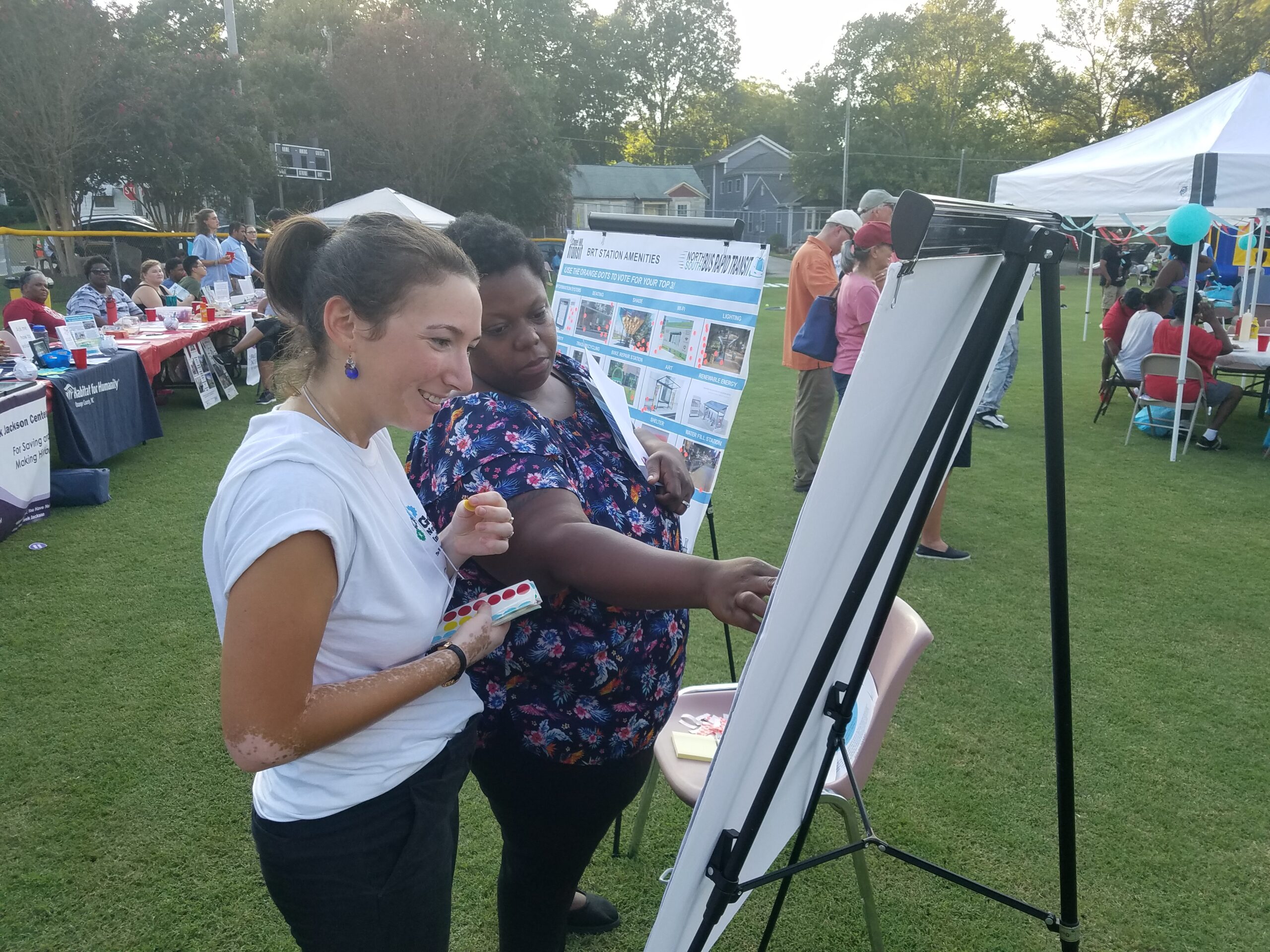 Members of the public viewing informational project boards at the Northside Neighborhood Night Out event.